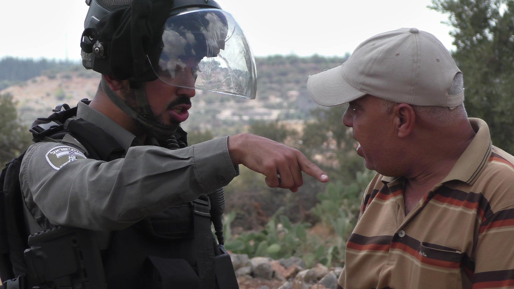 Ibrahim Amireh arguing with an Israeli soldier during the protest in west bank village of Ni'lin. photo credit: Ni'lin media center- Hassan Daboos